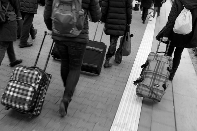 MUNICH, GERMANY - DECEMBER 15: (EDITOR'S NOTE: Image has been shot in black and white. Color version not available.) Passengers pull their suitcases on a platform after arriving on a train of German state railway carrier Deutsche Bahn at Hauptbahnhof main railway station on December 15, 2017 in Munich, Germany. The season before Christmas is always a busy annual travel period across Germany. (Photo by Sean Gallup/Getty Images)